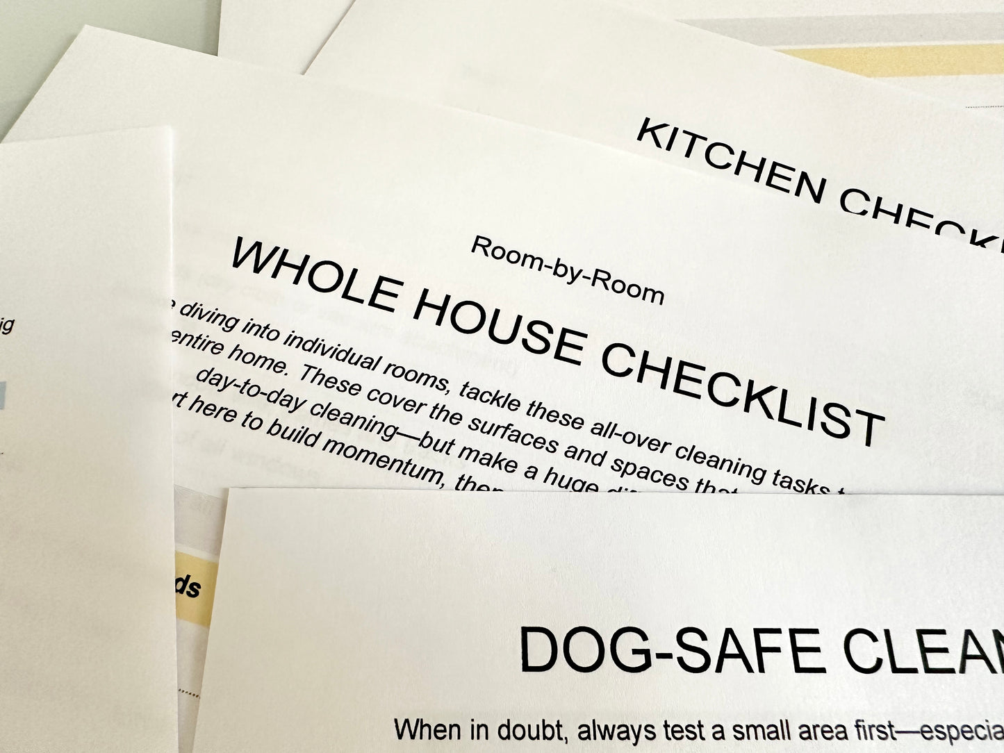 Photo of printed checklists, Room by Room, kitchen and whole house checklists.